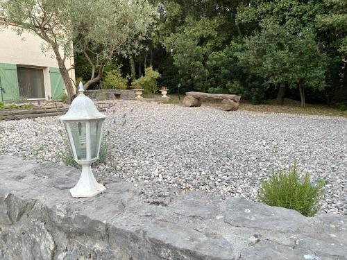 a street light sitting on top of a stone wall at Mas de Cala, gîtes détente au Pic Saint Loup in Saint-Mathieu-de-Tréviers