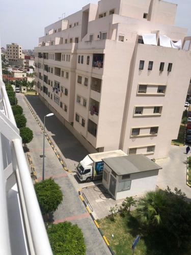 a white van parked in front of a building at Spacious Apartment F5 Tangier in Gzennaïa
