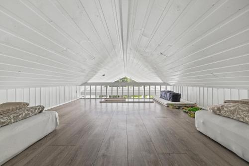 a large white room with two couches in it at Cozy Cabin - Golden Circle in Laugarvatn