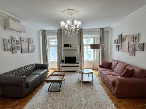 a living room with two couches and a table at City Pearl Apartment in Ljubljana