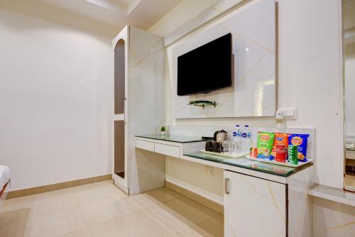 a bathroom with a counter with a sink and a tv at Hotel Krishna Deluxe-By RCG Hotels in New Delhi