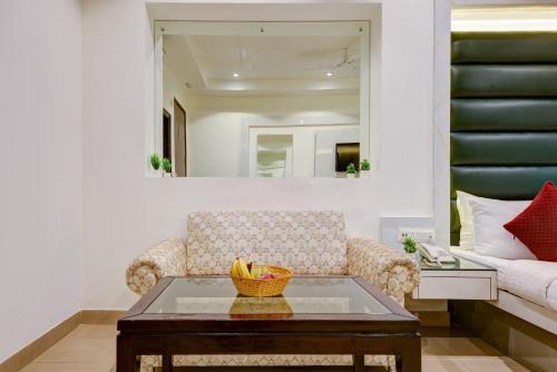 a living room with a couch and a table at Hotel Krishna Deluxe-By RCG Hotels in New Delhi