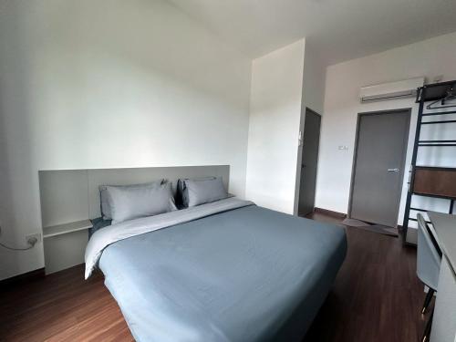 a bedroom with a large bed with white sheets and pillows at The Moonlight Valley Sri Indah in Sandakan