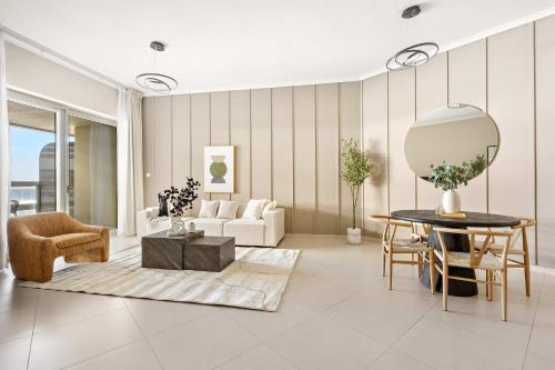 a living room with a table and a couch at Silkhaus Vacation Homes Ajwan Tower 1BR with Maid room in Saadiyat Island in Abu Dhabi