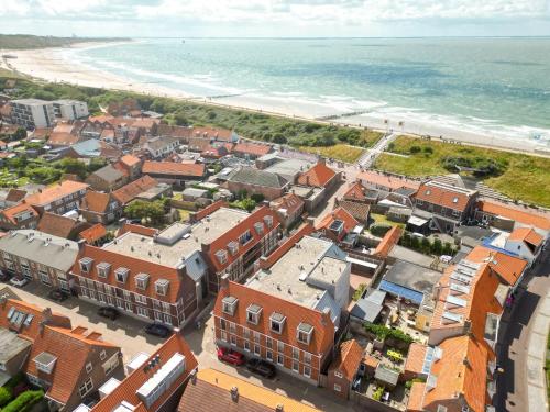 an aerial view of a town next to the beach at Welcome in - Aparthotel Zoutelande, studio's en app voor 2-6 pers - 50m van het strand in hartje centrum in Zoutelande