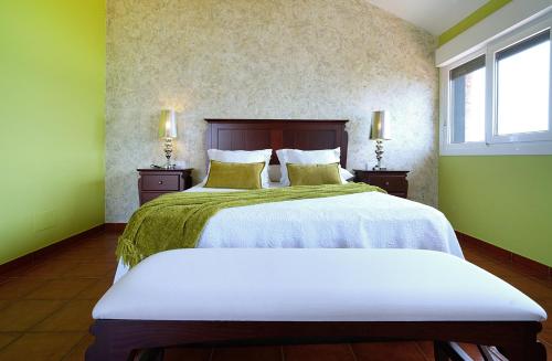a bedroom with a large bed with green walls at GALIHOST- Casa con impresionantes vistas al mar en Raxó in Raxo