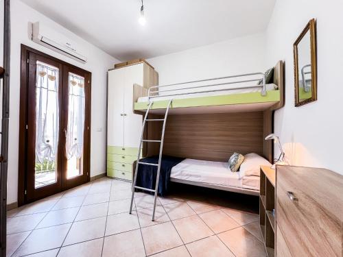 a room with a bunk bed with a ladder in it at Ginestra house in Olbia