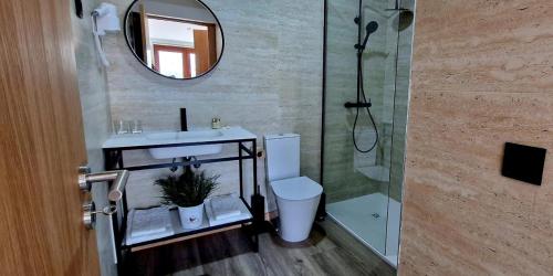 a bathroom with a shower and a toilet and a sink at Foz House Sabor & Douro in Torre de Moncorvo