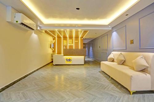 a living room with a white couch and a table at FabExpress Baba's Inn Kirti Nagar in New Delhi