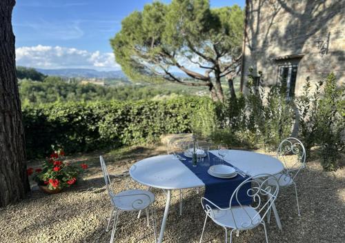 a blue table and chairs sitting on top of a field at Podere di Montecchio - Le Andane in Tavarnuzze