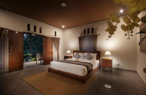 Katil atau katil-katil dalam bilik di Dhanya Villa Karangasem by Parigata