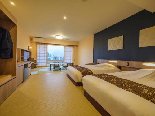 a hotel room with two beds and a table at Mizunoto Reopening on April 1, 2025 in Hakone