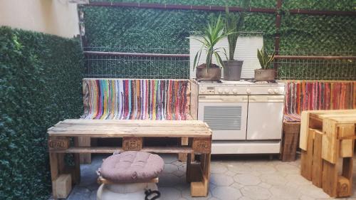 a kitchen with a table and a stove and a bench at Helios Hotel&Hostel in Shkodër