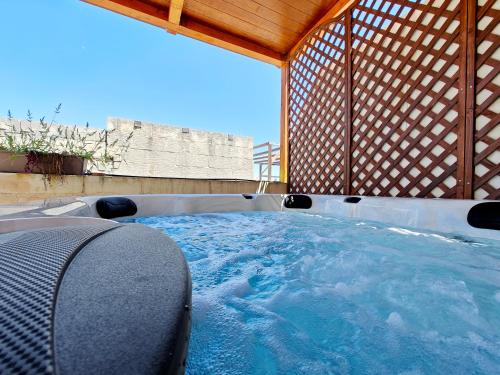 a hot tub in a gazebo with at Zebbuga The Penthouse Suite 7 in Żebbuġ