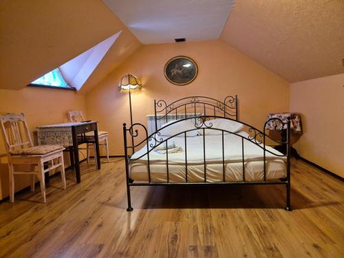 a bedroom with a bed and a table and a window at Bocianówka in Baranów Sandomierski