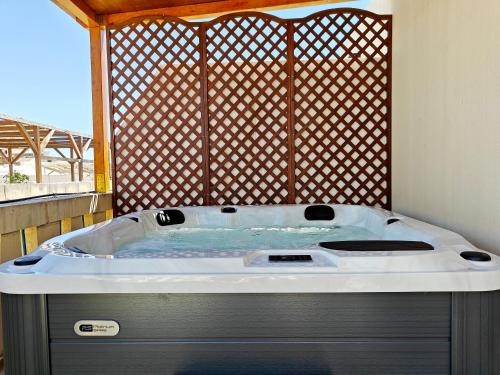a jacuzzi tub sitting on top of a porch at Zebbuga Tranquil Suite with Balcony 5 in Żebbuġ