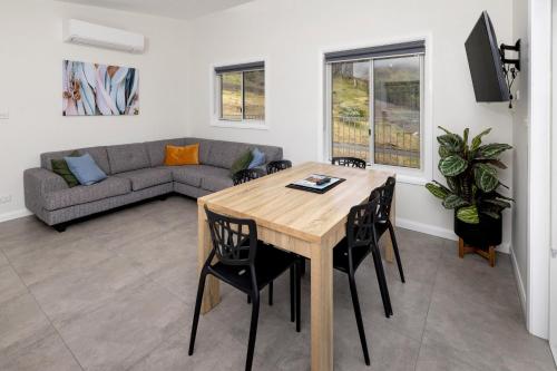 a living room with a table and chairs and a couch at BIG4 Launceston Holiday Park in Launceston