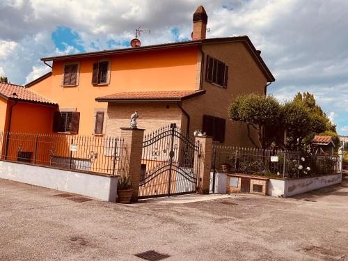 a large house with a gate in front of it at VILLA PATTY ASSISI con SPA in Assisi