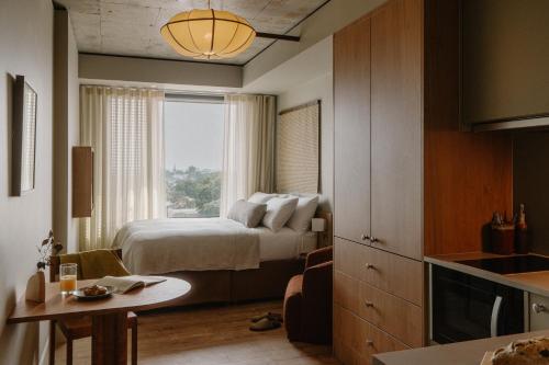 a hotel room with a bed and a window at Mason & Fifth, Westbourne Park in London