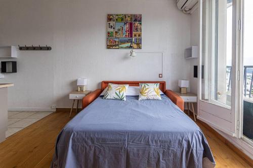 a bedroom with a bed and two tables with lamps at Studio 181 Albion Residence Beautiful view and pool! in Aix-les-Bains