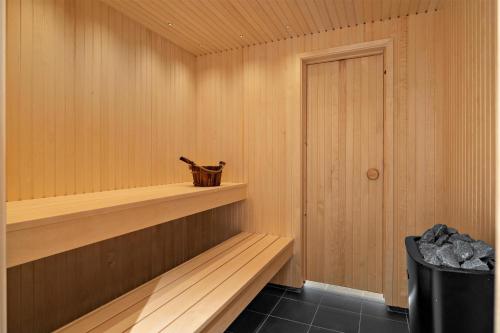 a sauna with a wooden shelf and a door at Best Western Hotel City Gavle in Gävle