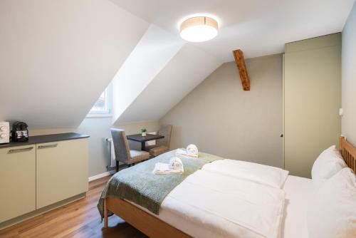 a bedroom with a bed in a attic at BetweenLakes Studio 2nd floor in Interlaken