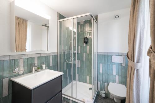 a bathroom with a sink and a shower at BetweenLakes Studio 2nd floor in Interlaken