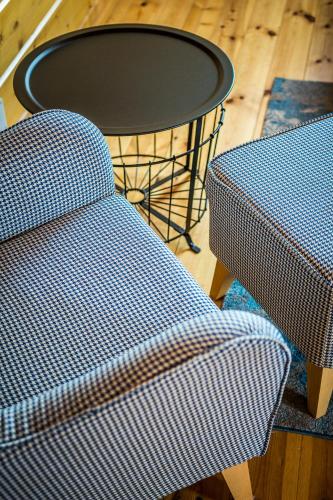 a table and a chair and a table and a table at Etiuda Zakopane in Zakopane