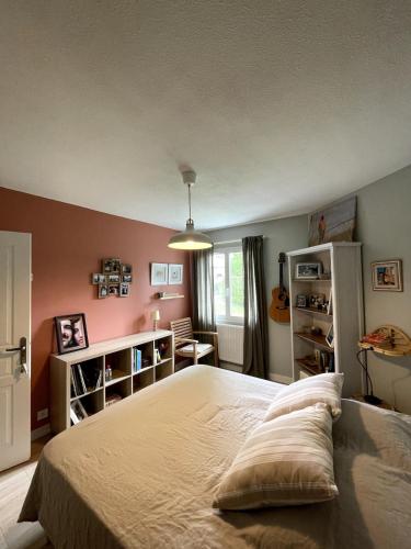 une chambre avec un grand lit dans une pièce dans l'établissement Villa aux portes du médoc, à Saint-Aubin-de-Médoc