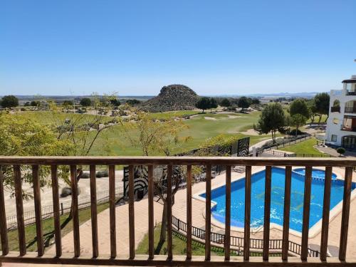 a view of a swimming pool from a balcony at El Valle Golf Resort in Baños y Mendigo