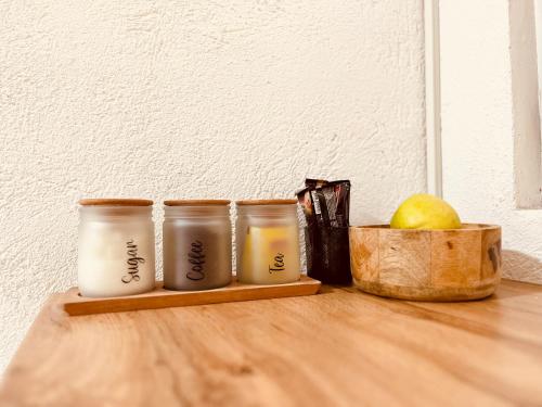 a table with three candles and a bowl of fruit at Zayed Residence in Mostar