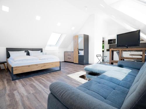 a living room with a couch and a bed at Landhotel Kirchberg in Kirchberg an der Jagst
