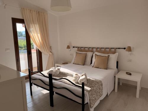 a bedroom with a bed with towels on it at CasaNica - Elegant independent apartment in Torpè