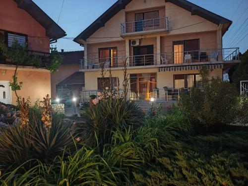 a large house with a balcony in front of it at Vila Nina 