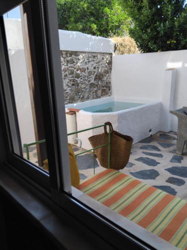 a view from a window of a tub on a patio at Pé na Terra Quintal in Reguengos de Monsaraz