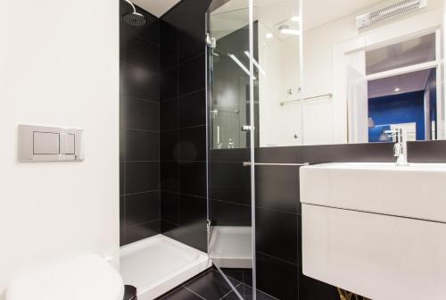 a bathroom with a white sink and a shower at FLH Baixa Blue Apartment in Lisbon
