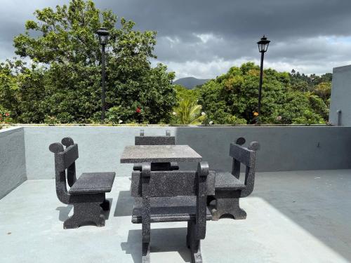 a table and chairs sitting on top of a patio at Hasthi Boutique in Kandy