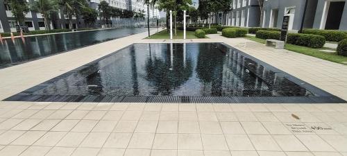 a swimming pool in the middle of a building at J&K Guesthouse at Harmoni Apartment, Eco Majestic in Beranang