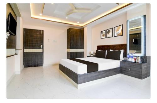 a bedroom with a large bed and a television at Hotel B N PALACE in kolkata