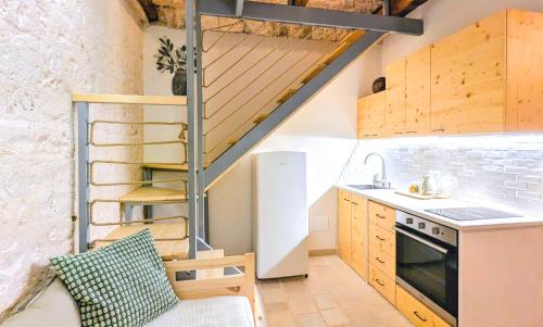 a small kitchen with a staircase in a tiny house at Trulli Panoramici in Alberobello