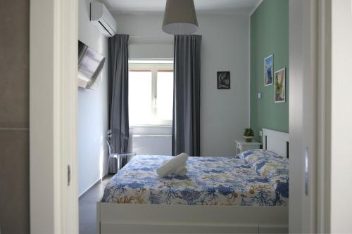a bedroom with a bed and a window in it at Nonna Francesca 2 in Patti