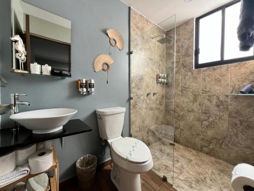 a bathroom with a toilet and a sink and a shower at Promo! 2BR-Pool-Views-King Bed-Walk 2 Beach-5 Star Area in Mazatlán