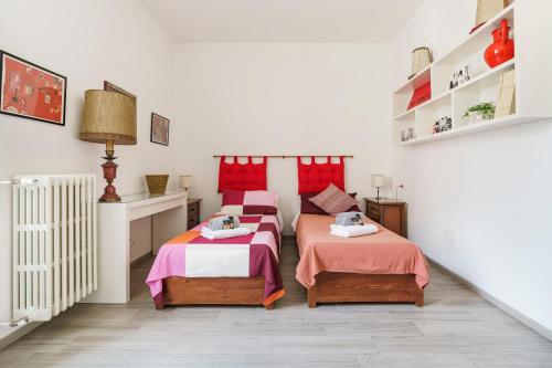 a bedroom with two beds and a radiator at Chianti House, Florence in Florence