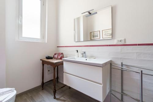 a white bathroom with a sink and a mirror at Chianti House, Florence in Florence