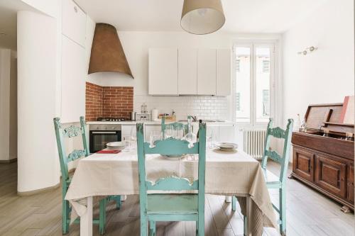 a kitchen with a table with blue chairs at Chianti House, Florence in Florence