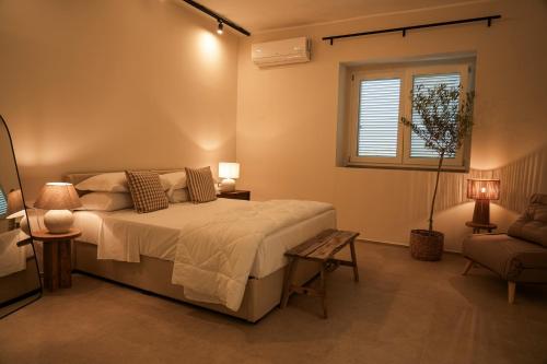 a bedroom with a bed and a window and a chair at Si Sofia country house in Capaccio-Paestum