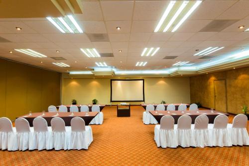 a conference room with tables and chairs and a screen at Unwind in Style Villa La Estancia Cabo in Cabo San Lucas