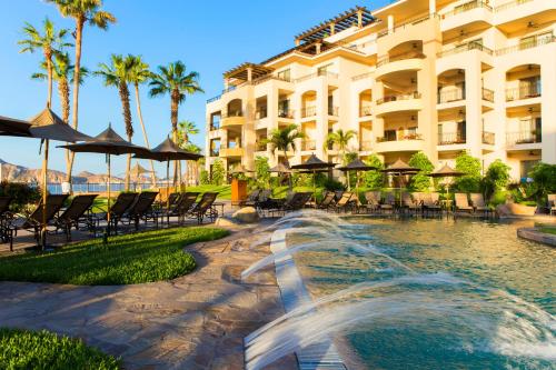 a hotel with a fountain in front of a swimming pool at Unwind in Style Villa La Estancia Cabo in Cabo San Lucas