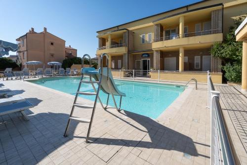 a ladder is next to a swimming pool at Hotel Residence Il Conero 2 in Numana