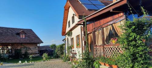 a house with solar panels on the side of it at Pensiunea Elena in Criţ